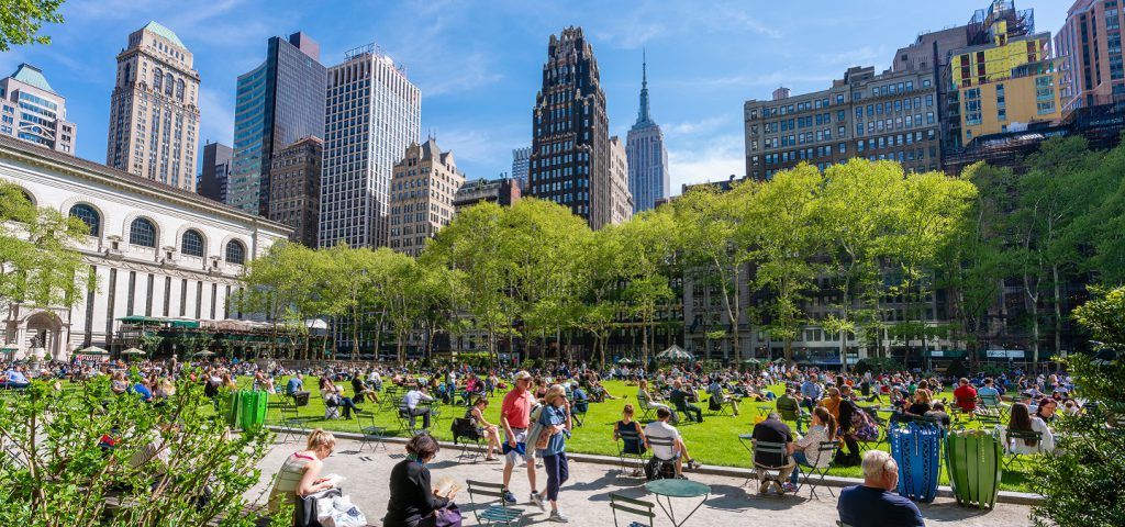 people in Midtown park during the day with building in the background.