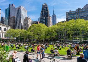 people in Midtown park during the day with building in the background.