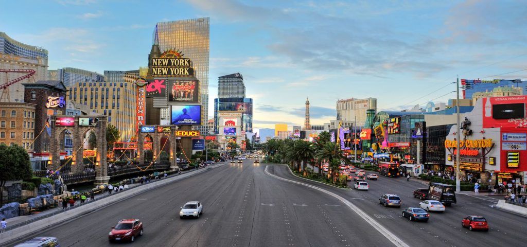 Las Vegas strip with cars and people.