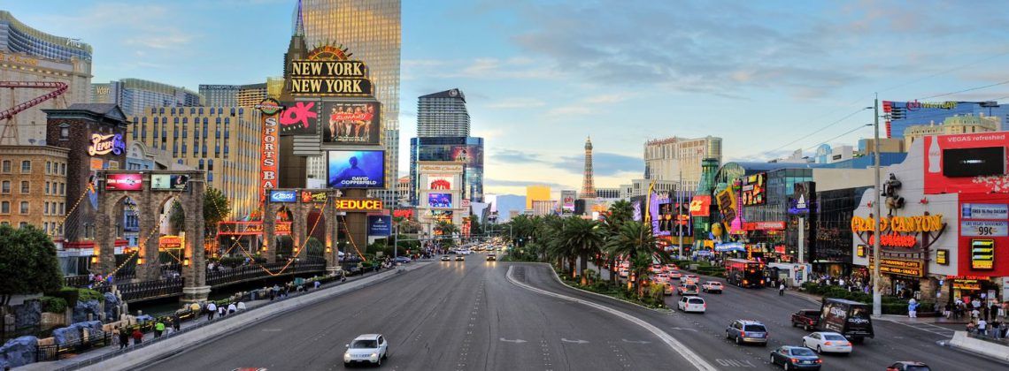 Las Vegas strip with cars and people.