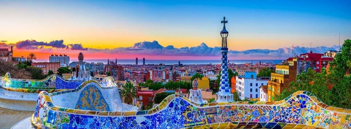 colorful mosaiuc overlooking the Barcelona skyline during sunset.
