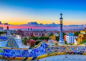 colorful mosaiuc overlooking the Barcelona skyline during sunset.