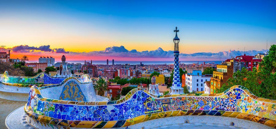 colorful mosaiuc overlooking the Barcelona skyline during sunset.