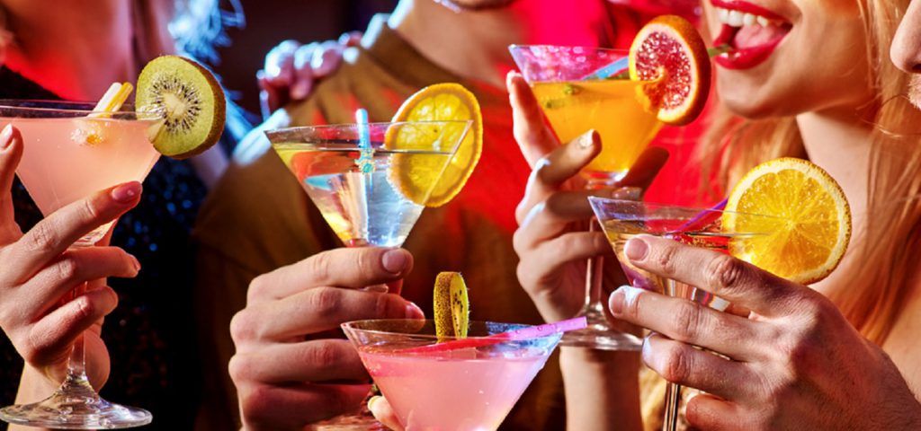 People holding various cocktails.