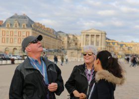 Palace of versailles with people in the square.