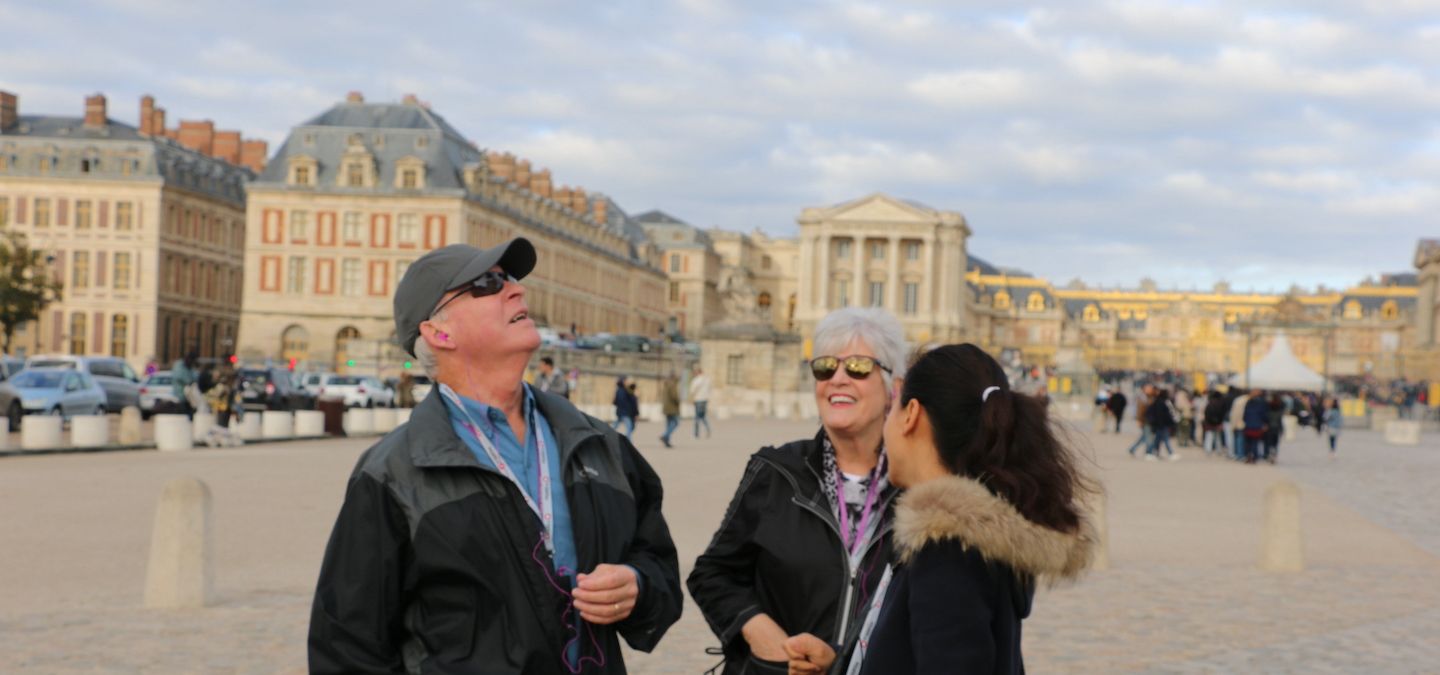 Palace of versailles with people in the square.