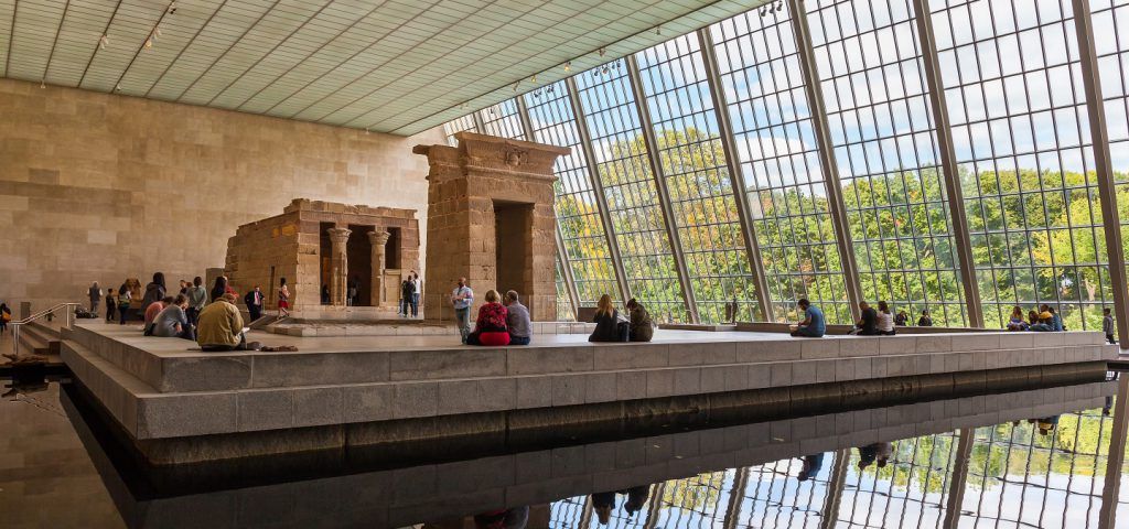 MET ruin exhibit with people sitting down and admiring.