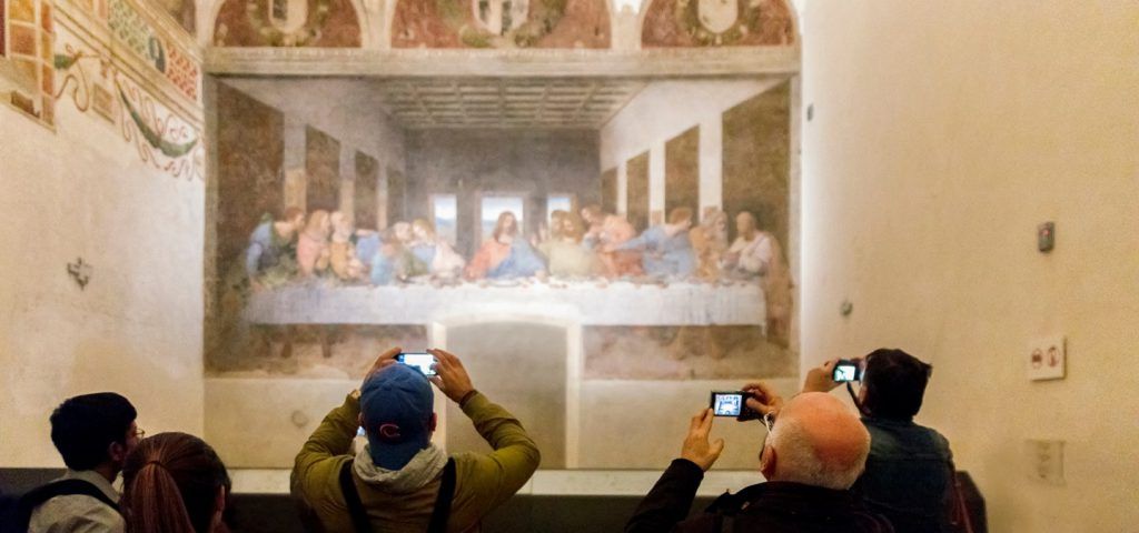 People taking pictures of The Last Supper by Leonardo da Vinci in Milan
