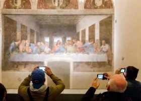 People taking pictures of The Last Supper by Leonardo da Vinci in Milan