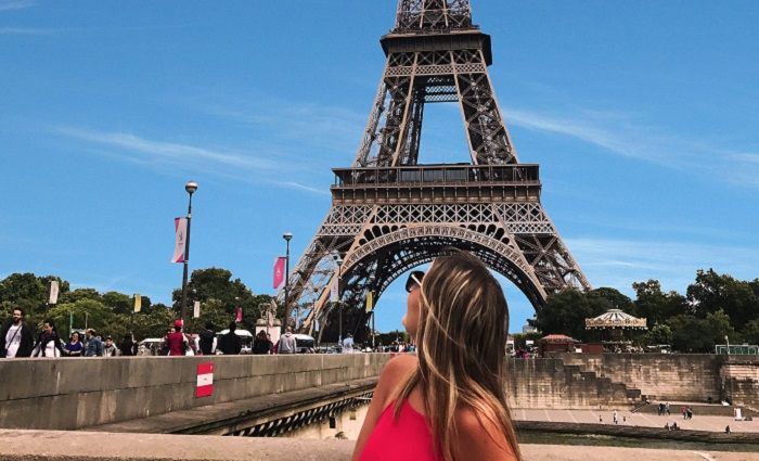 Woman in front of the Eiffel tower during the day