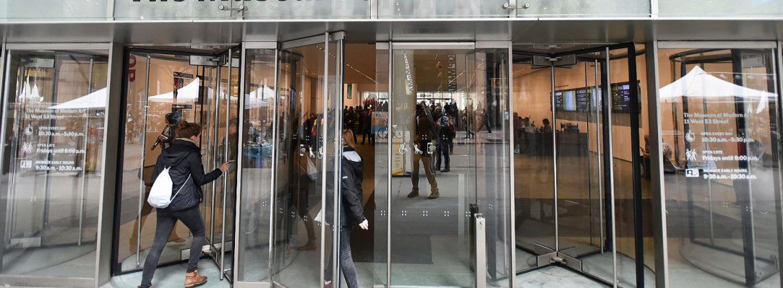 People walking into the Museum of Modern Art.