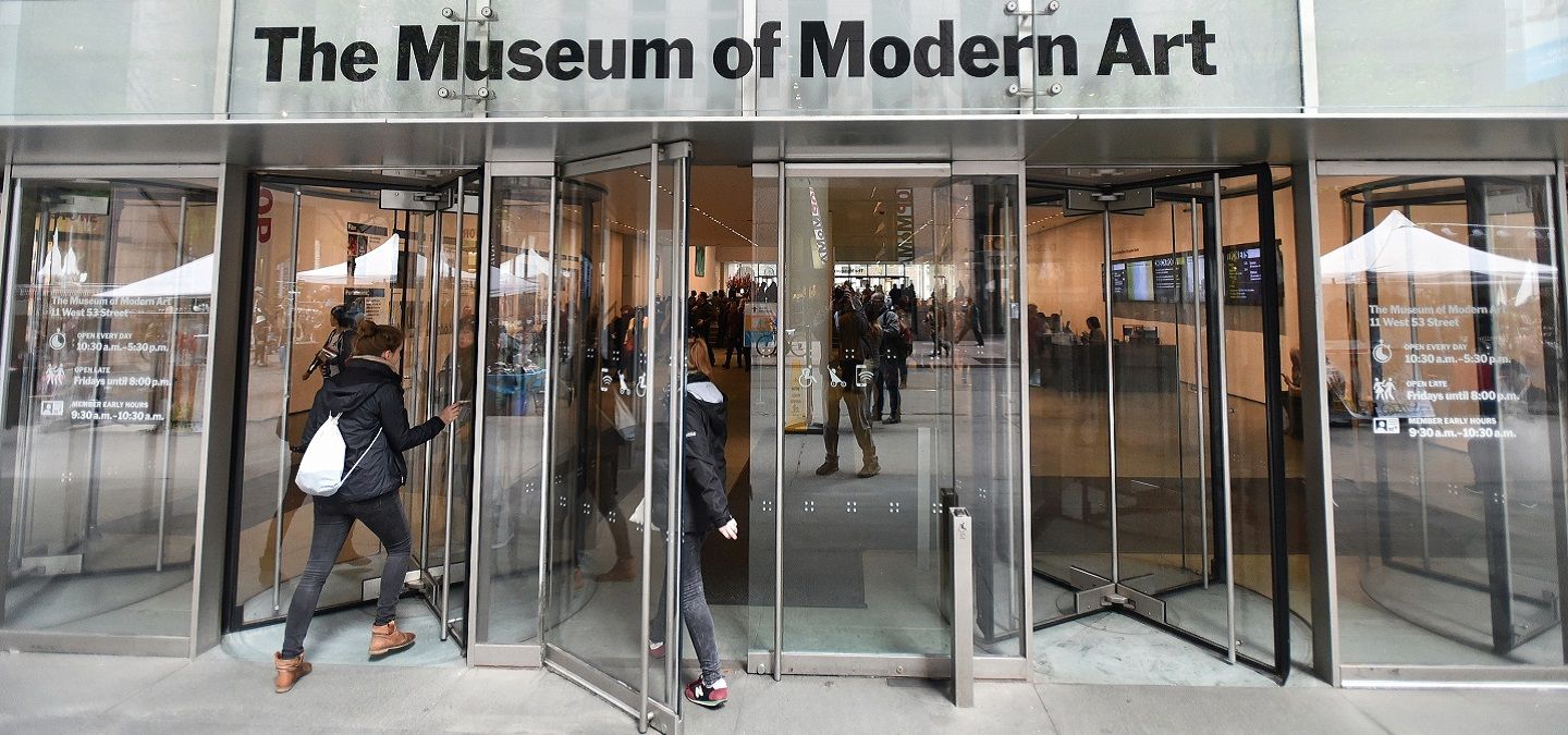 People walking into the Museum of Modern Art.