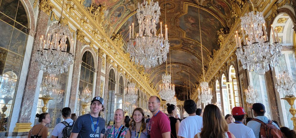 People taking a tour of the Palace of Versailles.