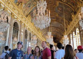 People taking a tour of the Palace of Versailles.