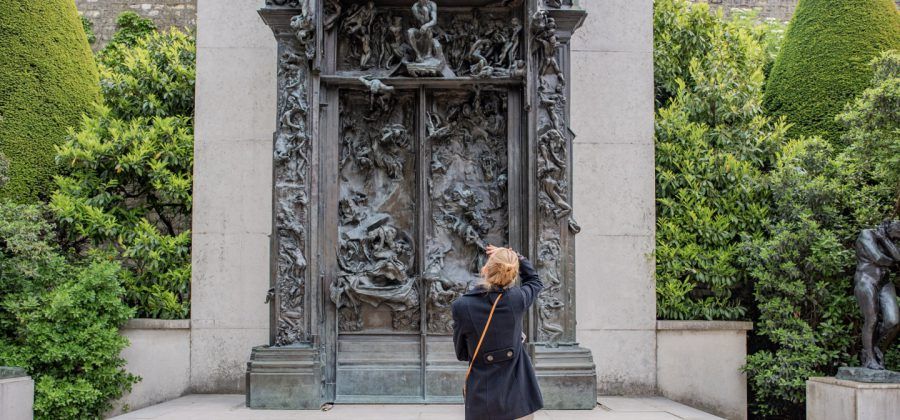 Woman looking at the gates of Musee Rodin.