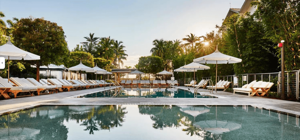 Pool and lunge chairs at sunset.