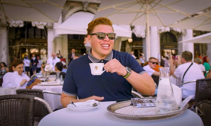 Man drinking coffee outside at the Caffe Florian