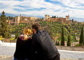 Couple looking at a castle in Granada.