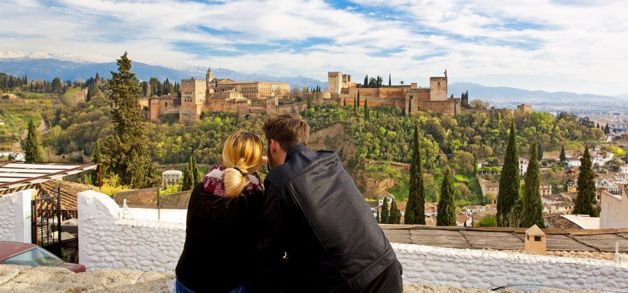 Couple looking at a castle in Granada.