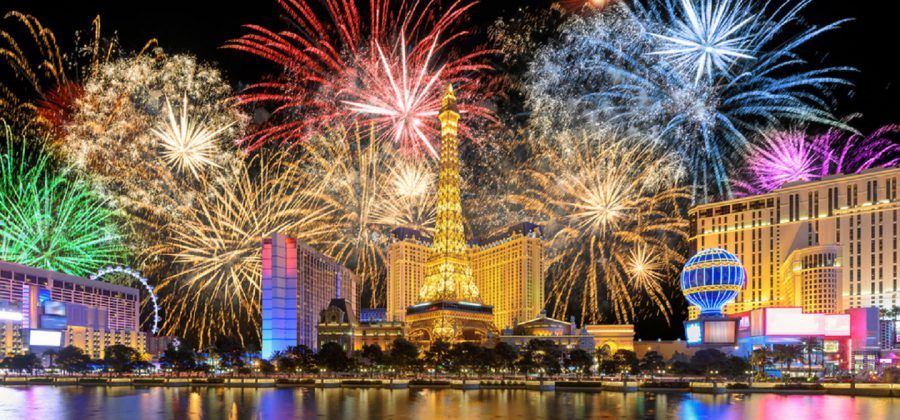 Las Vegas strip's Eiffel Tower with fireworks in the background at night.