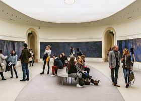 Group of people in the Monet Gallery at the musee l'orangerie.