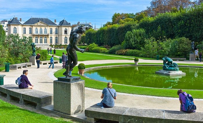 Visitors sitting in the gardens of the Musée Rodin in Paris 