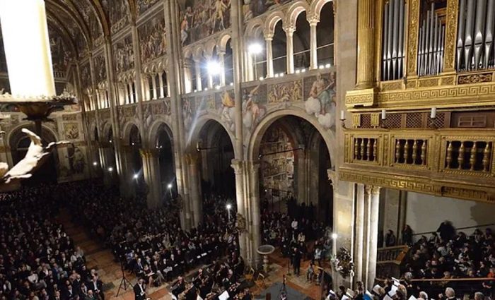 people at a concert inside the castle at lake como