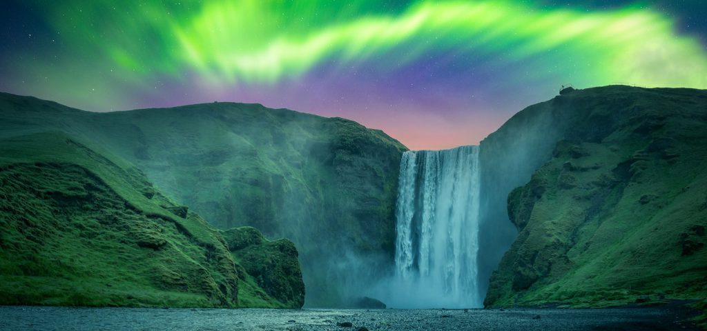 northern lights over skogafoss falls