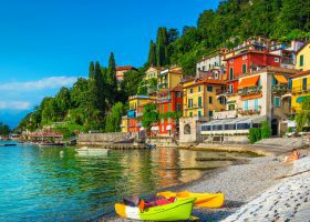 kayaks on shore with colorful houses