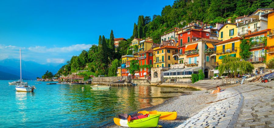 kayaks on shore with colorful houses