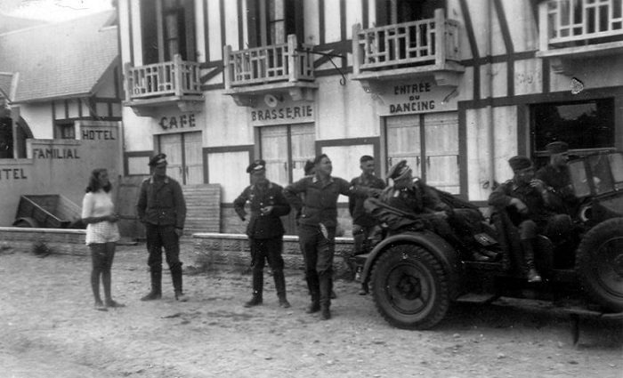 german soldiers and woman standing in french town