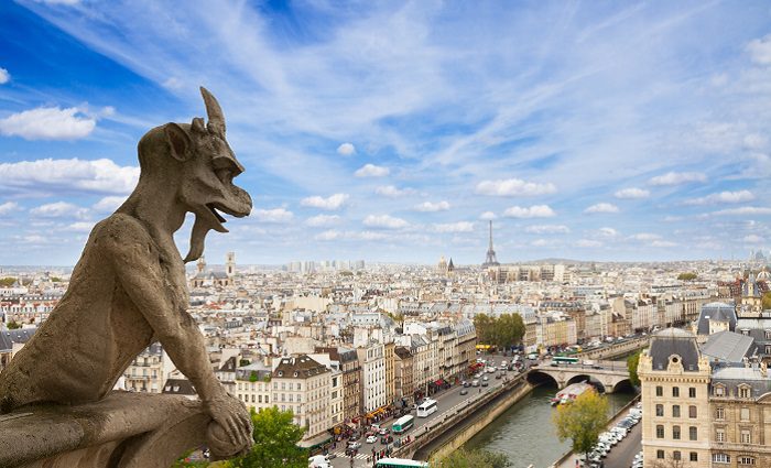 Gargoyle on top of church overlooking paris