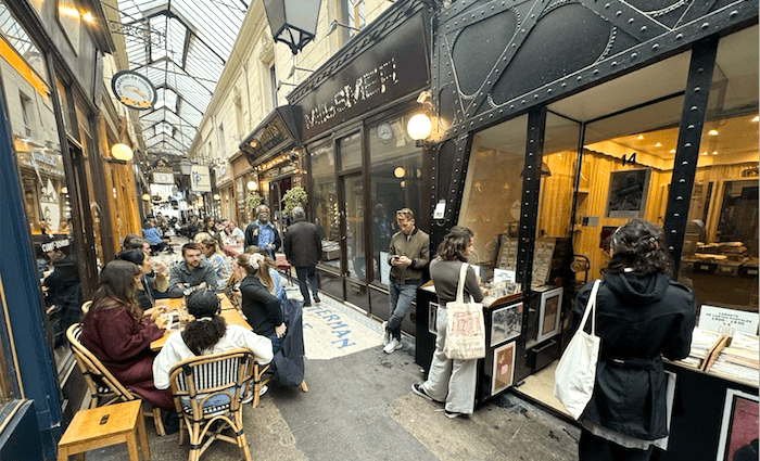 Sean P Finelli doing research in the Passage des Panoramas in Paris for guidebook