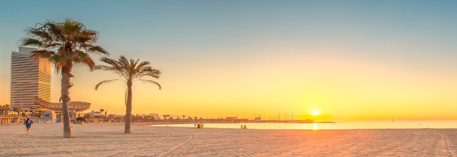 Barceloneta Beach in Barcelona with colorful sky at sunrise