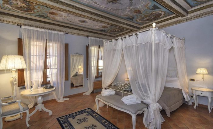 Painted ceilings, and a four-poster bed make this a romantic spot.