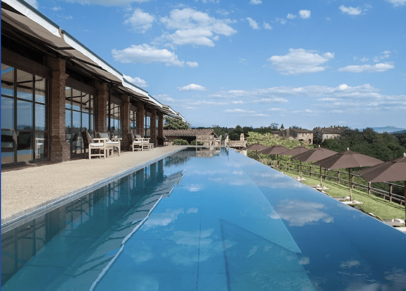 The infinity pool with a view over the Medieval hamlet and the Arezzo countryside.