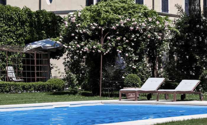 The poolside of the B&B. Surrounded by mature gardens with the villa in the background.