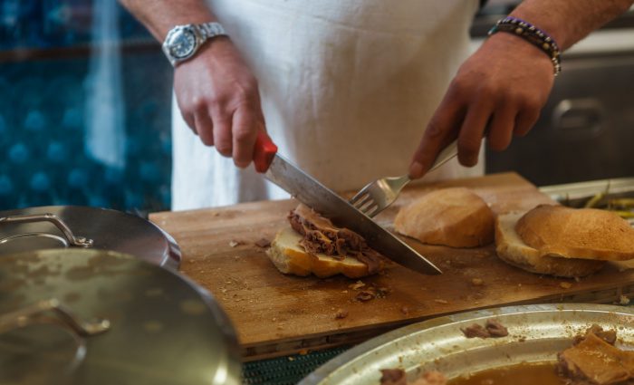 A chef prepares a delicious panini