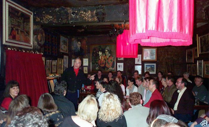 The interior of au lapin agile with a cabaret performer