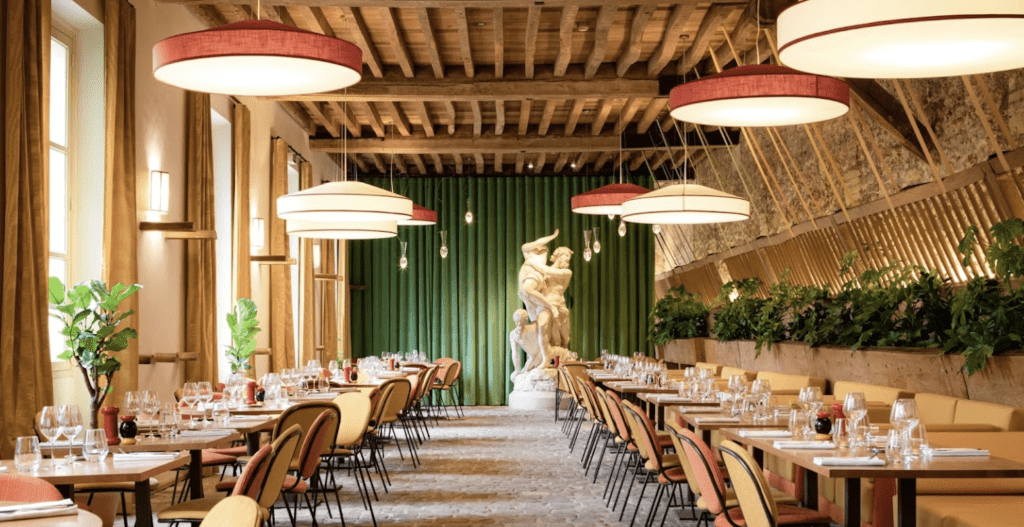 Cobblestone floors and wooden beams on the ceiling with an Italian statue in the center.