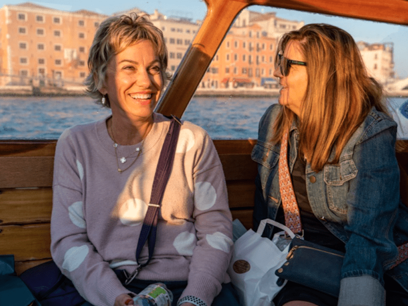 Two women enjoy a private boat on one of the best Murano and Burano tours.