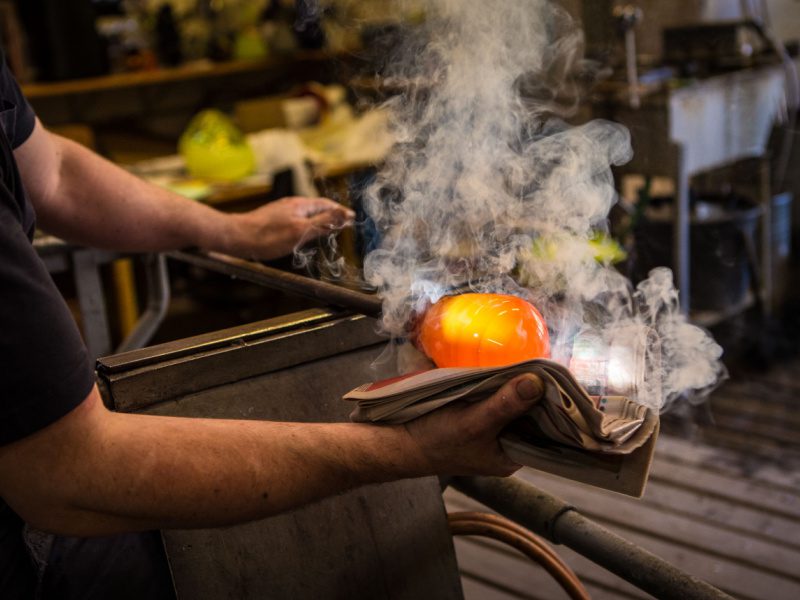a skilled craftsman shapes glass in the workshop on one of the best Murano and Burano tours