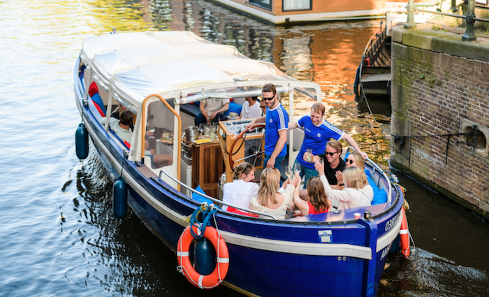 A group enjoying a luxury canal cruise, one of our best tours of Amsterdam.