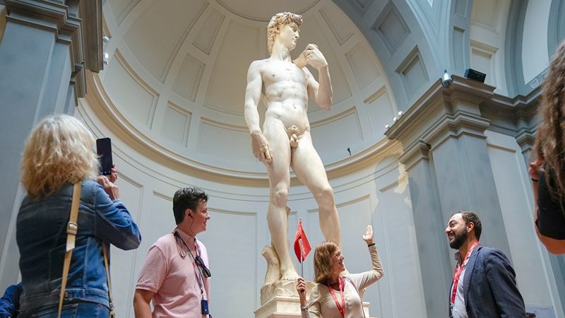 a group enjoying the David, a cool addition to one of the best tours of the Duomo.