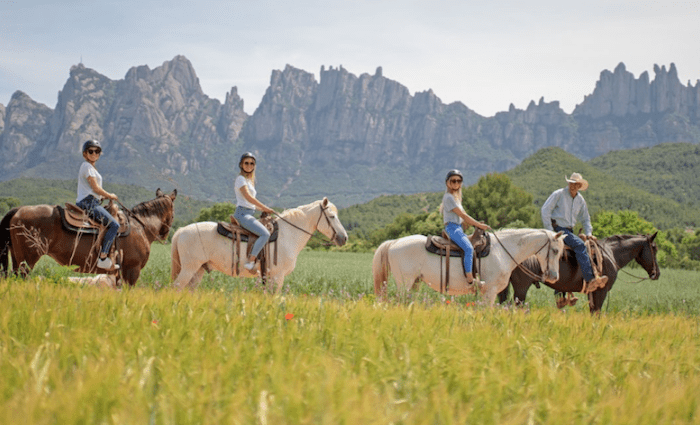 a group horseback riding in Montserrat, one of the best tours in Barcelona