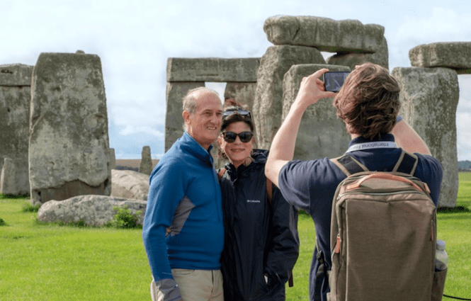 Is a tour of Stonehenge worth it. A smiling couple infront of the stone circle think so.