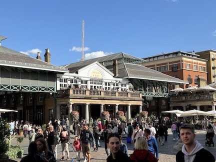 People walking in front of a "Covent Garden Market" sign.