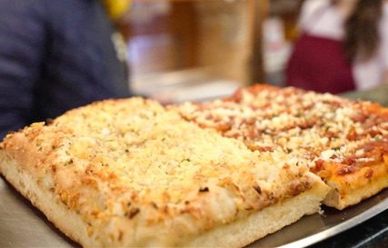 Square-cute pizza topped with parmesan cheese.