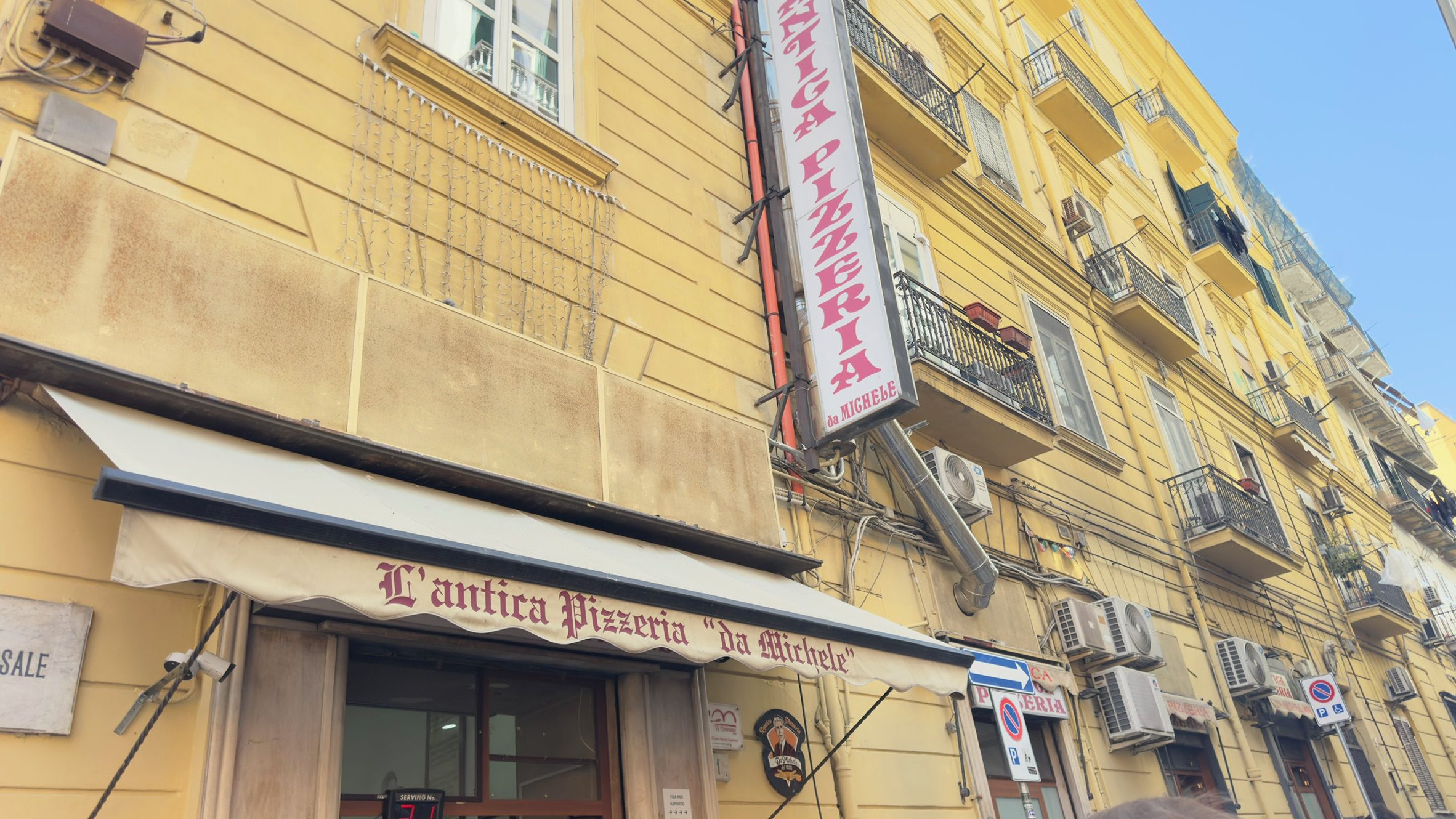 A sign for L'antica Pizzeria Da Michele. 