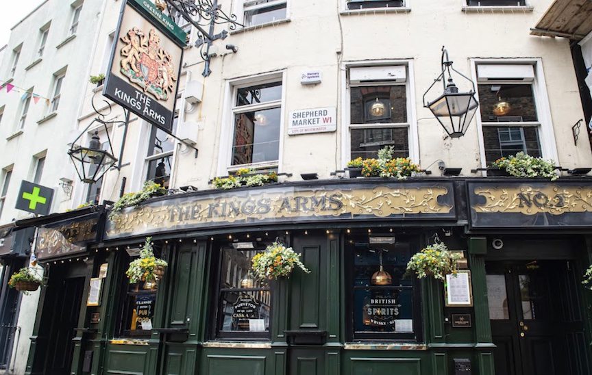 A painted green bar with hanging flowers.